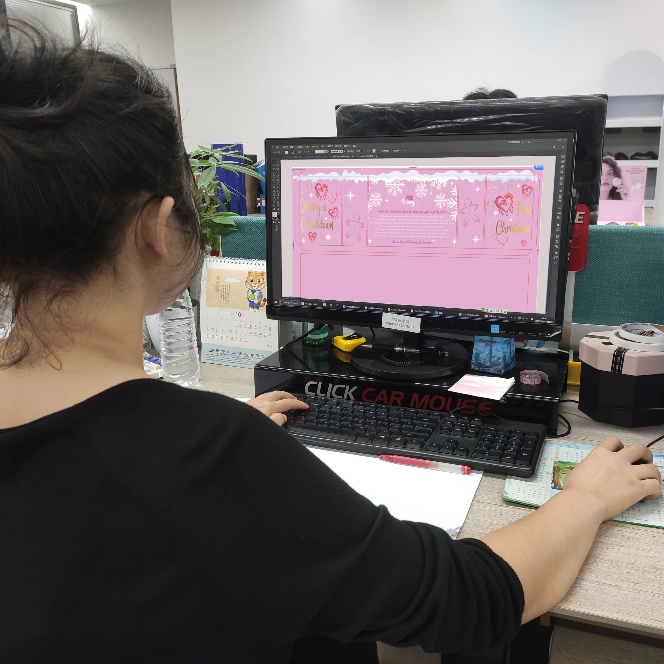 A designer looking at custom packaging options on a computer screen.