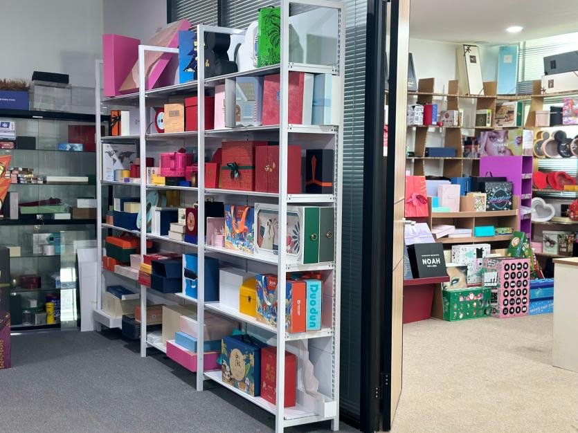 A shelf with various branded boxes, one of which stands out due to its unique design.