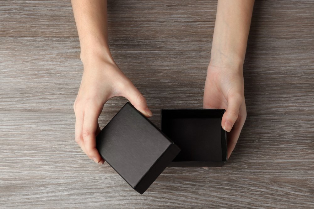 a hand touching the texture of a luxury packaging box