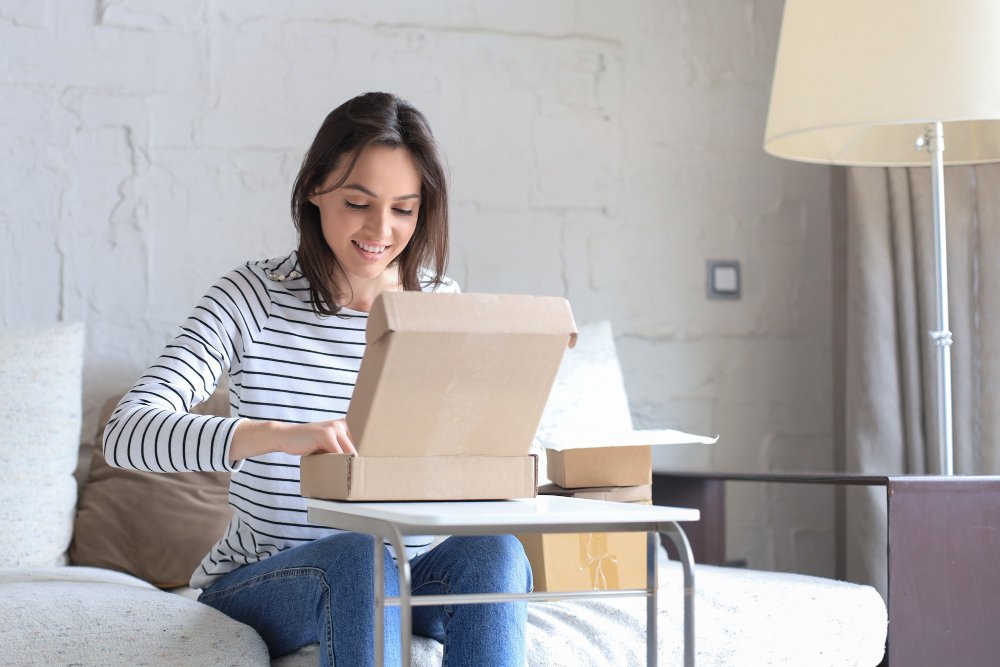 A customer happily unboxing a custom mailer box