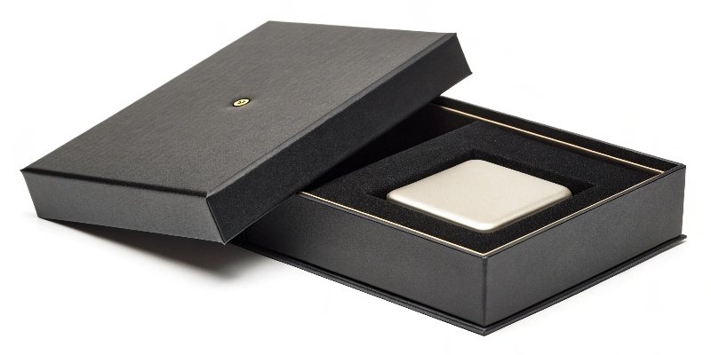 A sleek two-piece rigid box, with the lid slightly lifted to reveal a product nestled inside.