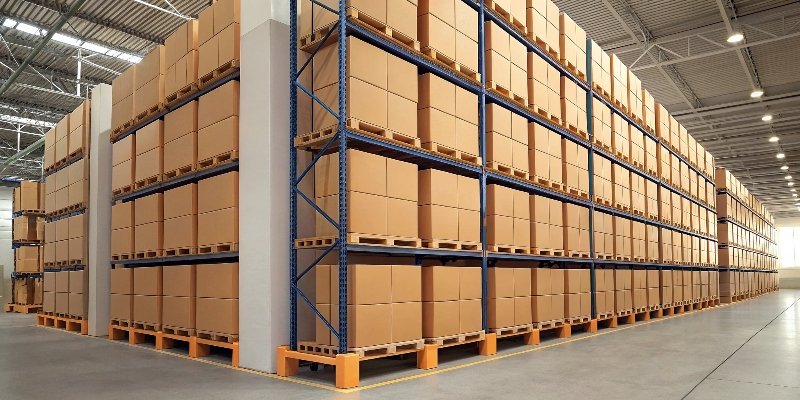 A warehouse shelf packed with assembled rigid boxes, taking up a lot of space.