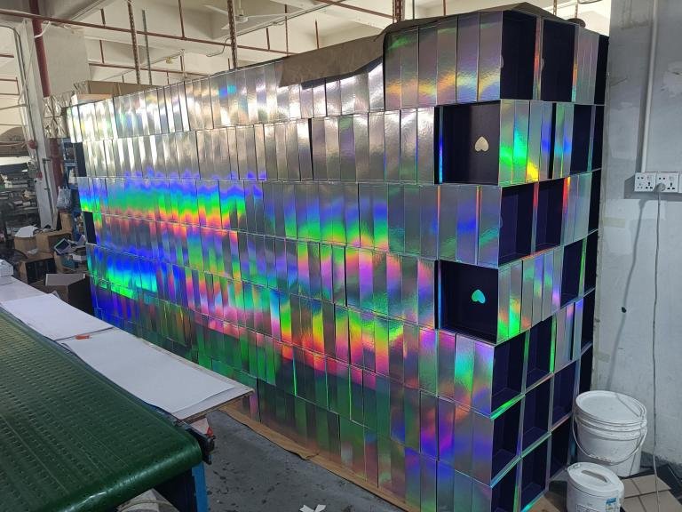 A factory floor showing the mass production of custom rigid boxes.