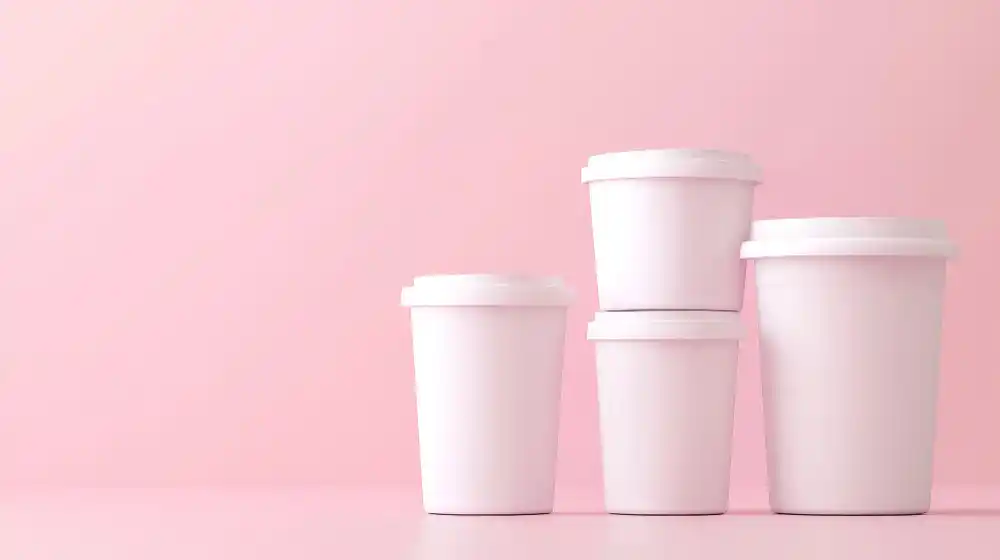 A collection of different sized ice cream containers on a clean background.