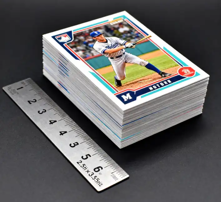 A stack of modern baseball cards next to a ruler showing the 2.5 by 3.5 inch dimensions.