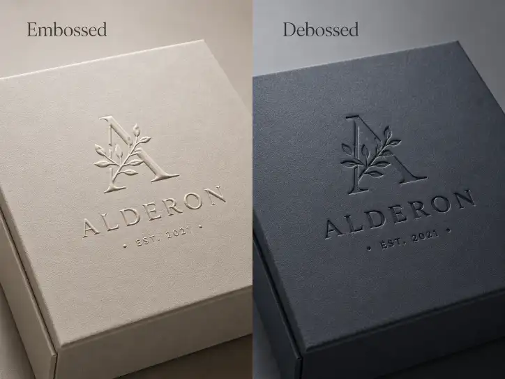 embossed logo raised above the surface of a rigid gift box next to a debossed logo pressed below the surface showing the tactile difference