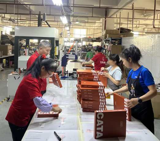 custom rigid box manufacturer factory production line with skilled workers assembling premium packaging boxes
