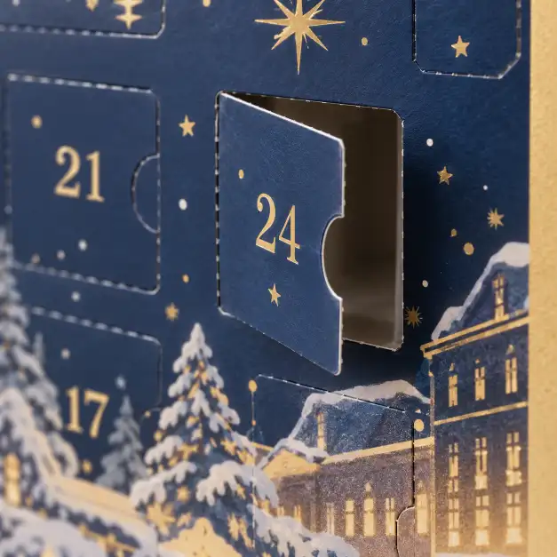 Perforated advent calendar door opening detail showing clean cutting and precise alignment